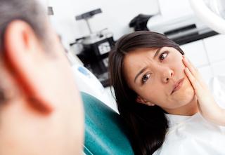 Woman with bad tooth pain at dentist in Rockville, MD | tooth extraction