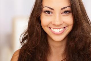 Patient smiling after teeth whitening in Rockville, MD