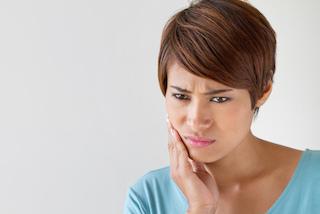 Woman with bad pain from root canal infection in Rockville, MD