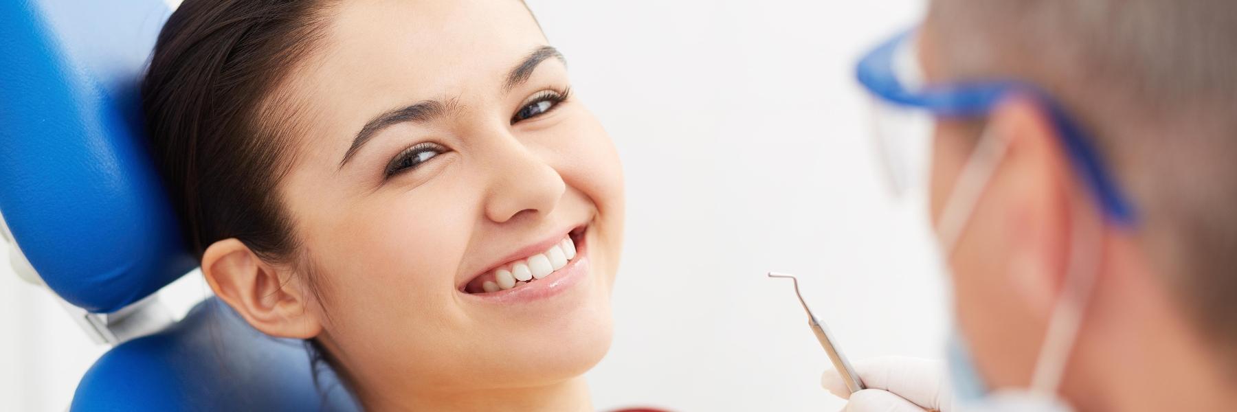Woman smiling in treatment chair at general dentist in Rockville, MD