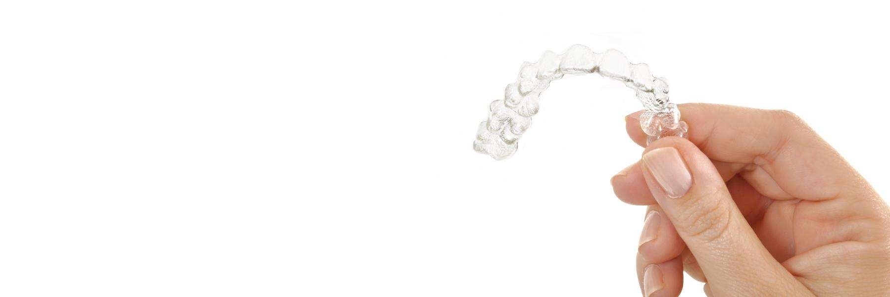 Hand holding up tray of Invisalign in Rockville, MD