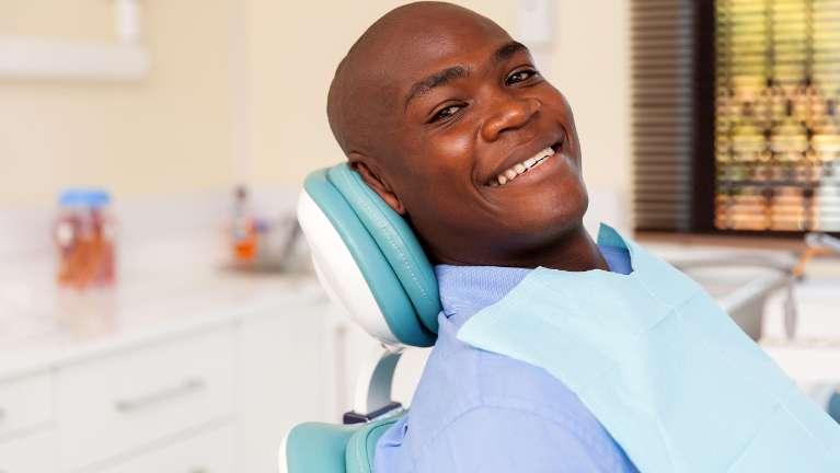 Man smiling in chair at dentist near me Rockville