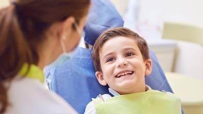 Young boy smiling at kid-friendly dentist in Rockville, MD