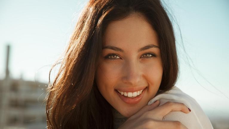 Woman smiling after cosmetic dentistry in Rockville, MD