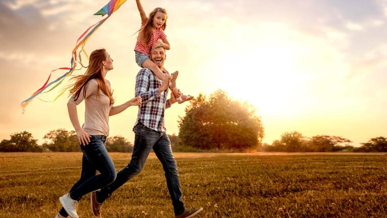 Parents and child playing at Fallsgrove Stream Valley Park in Rockville MD