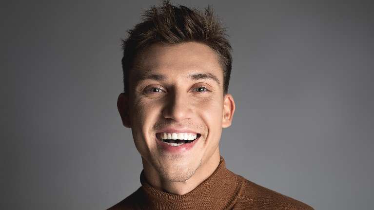 man with brown hair smiling | dentist rockville md