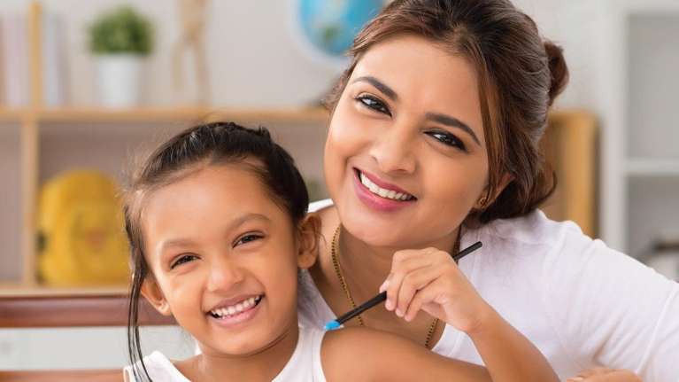 woman with daughter smiling | dentist rockville md