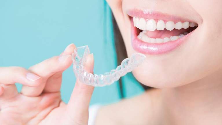 Woman holding tray of ClearCorrect aligners in Rockville, MD