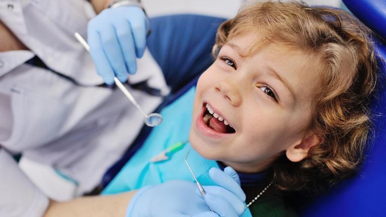 Young boy smiling at family dentist in Rockville MD