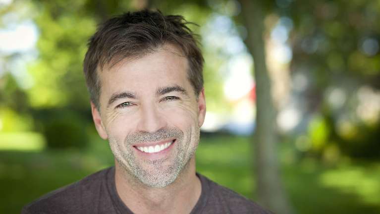 man smiling outside | emergency dentist rockville md