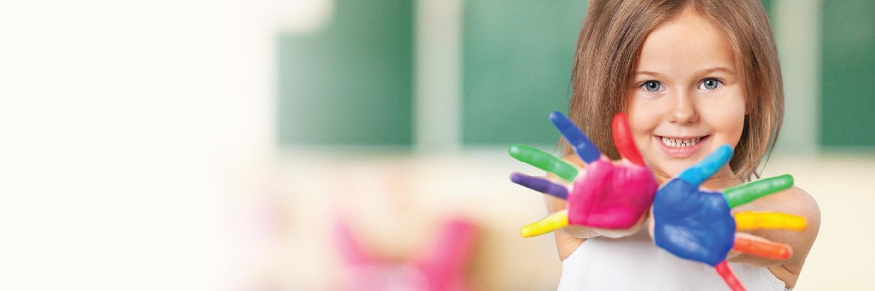Child with paint on their hands at children's dentist in Rockville, MD