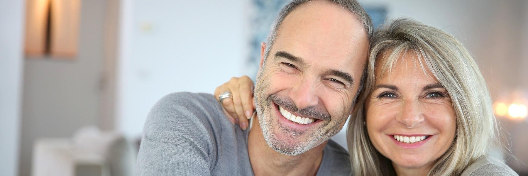 Couple with dental implants smiling in Rockville, MD